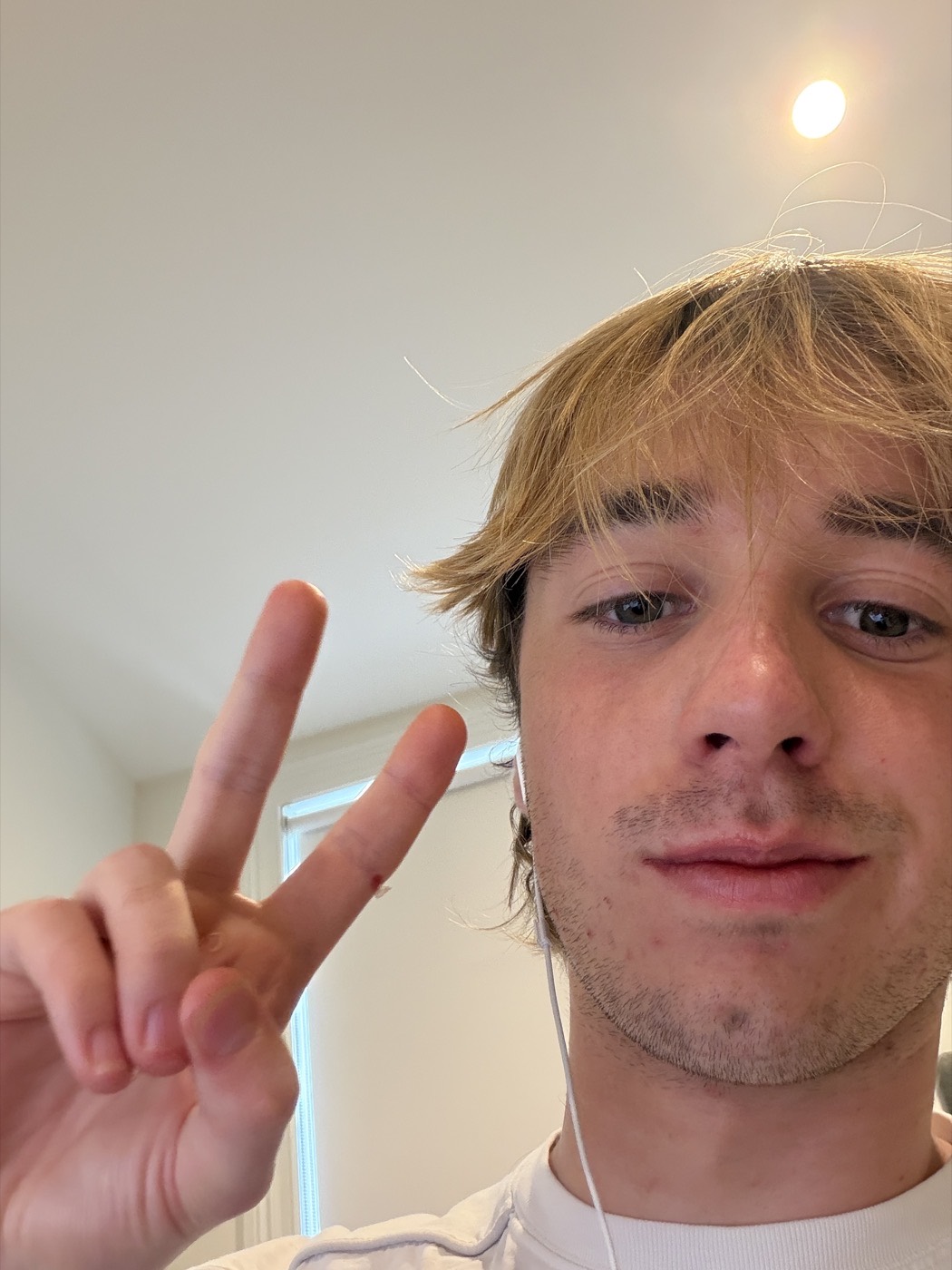 Hugo throwing up a peace sign.