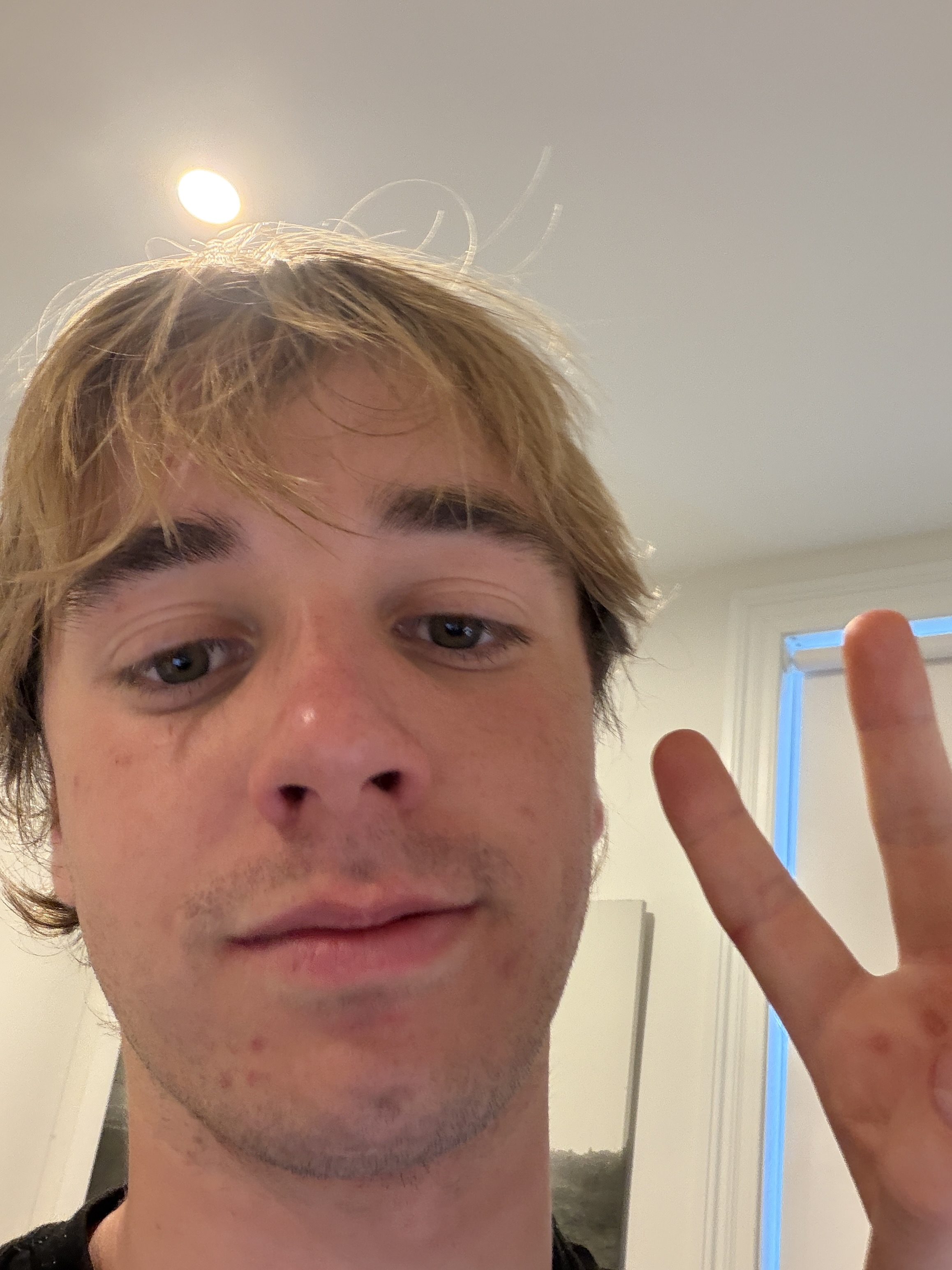Hugo's sign-off selfie, throwing a peace sign.